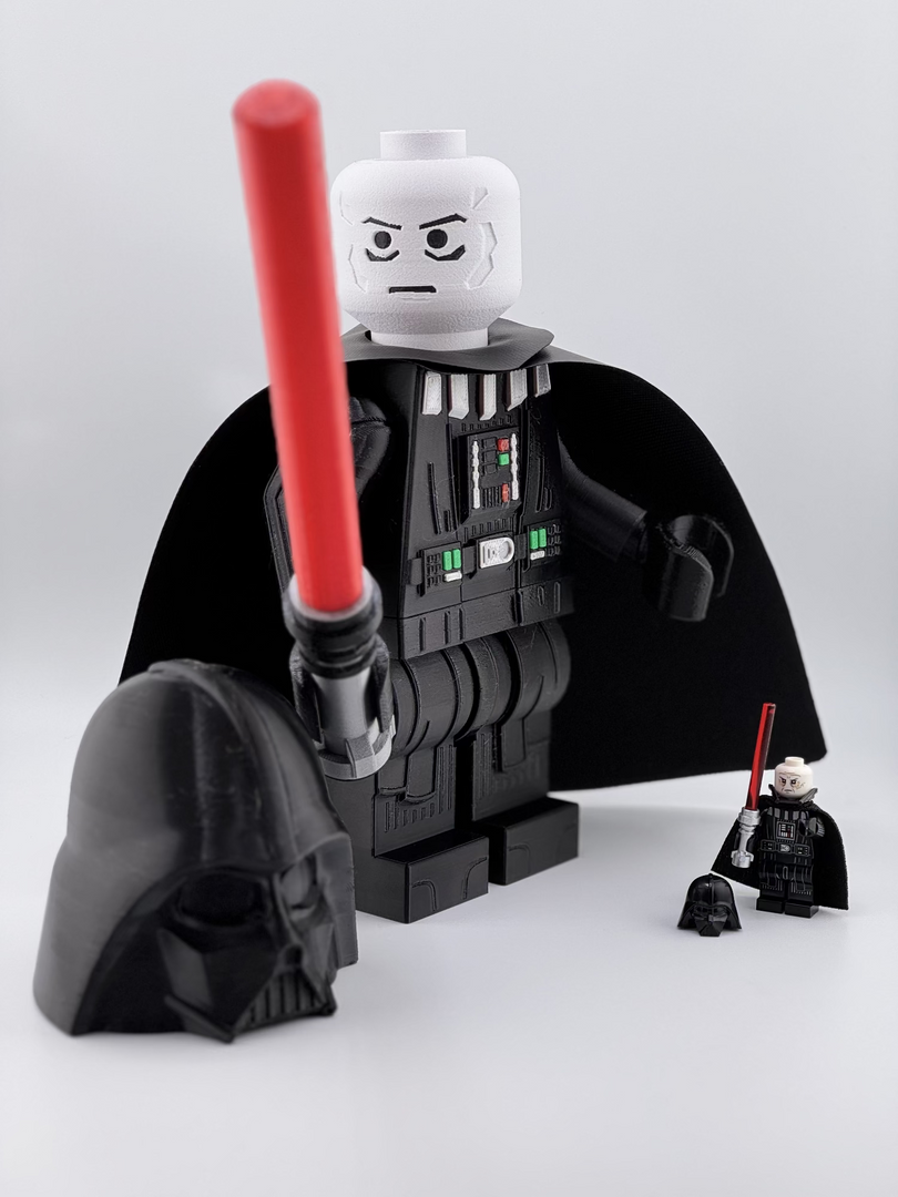 9" and mini LEGO Darth Vader figure with a red lightsaber on a white background